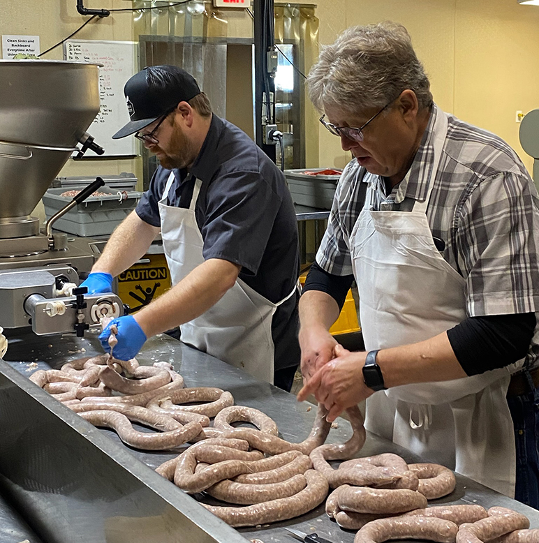 Premium Sausage staff processing custom sausage